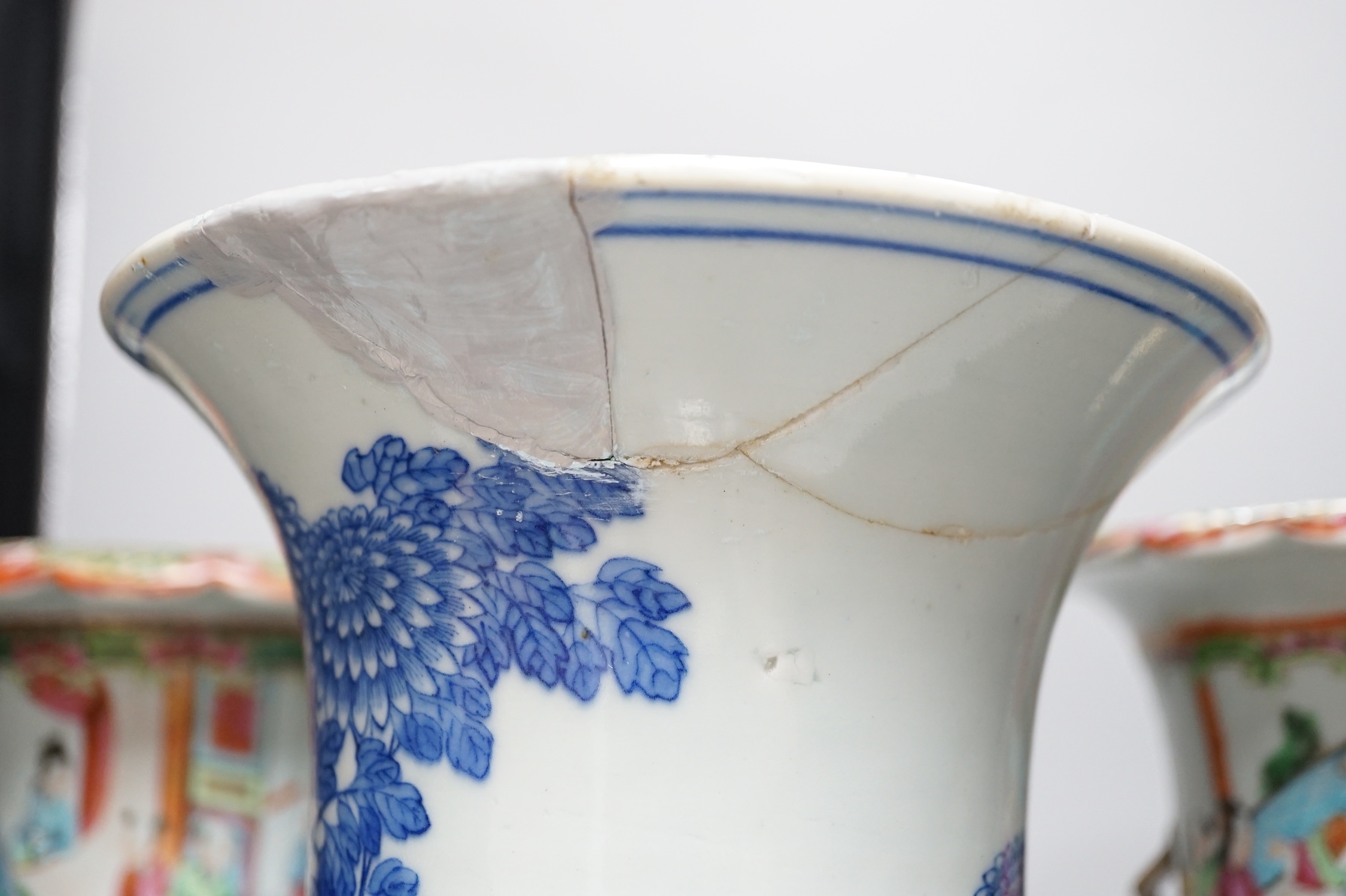 A pair of Chinese Canton decorated famille rose enamelled vases, 36cm high, an early 20th century Chinese blue and white baluster vase, 25cm (a.f.), a 19th century Chinese blue and white gu shaped vase, 37.5cm (a.f.), a